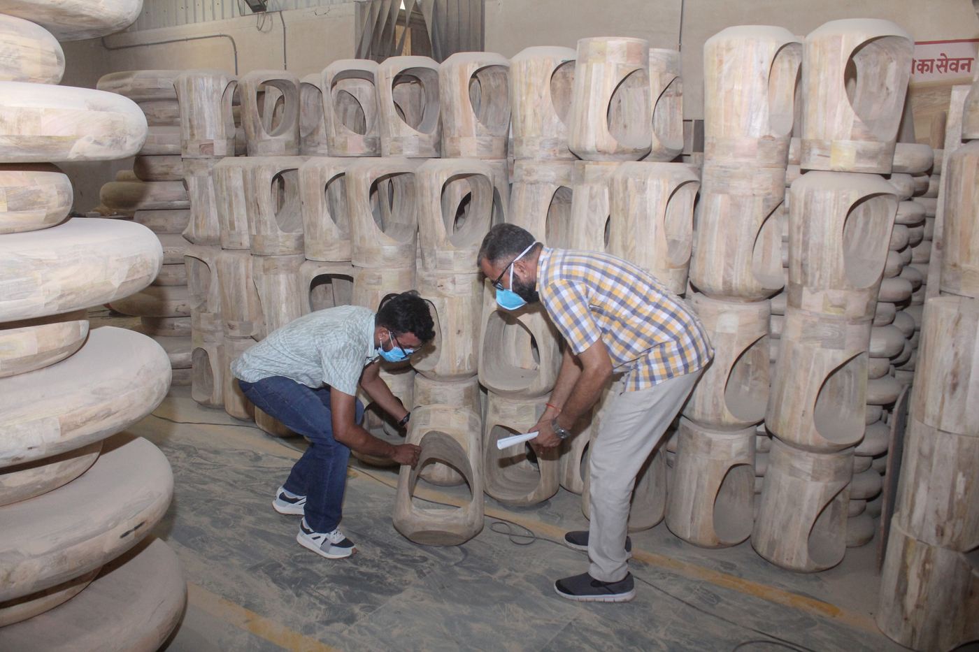7SOURCE INTL team inspecting furniture at a partner factory